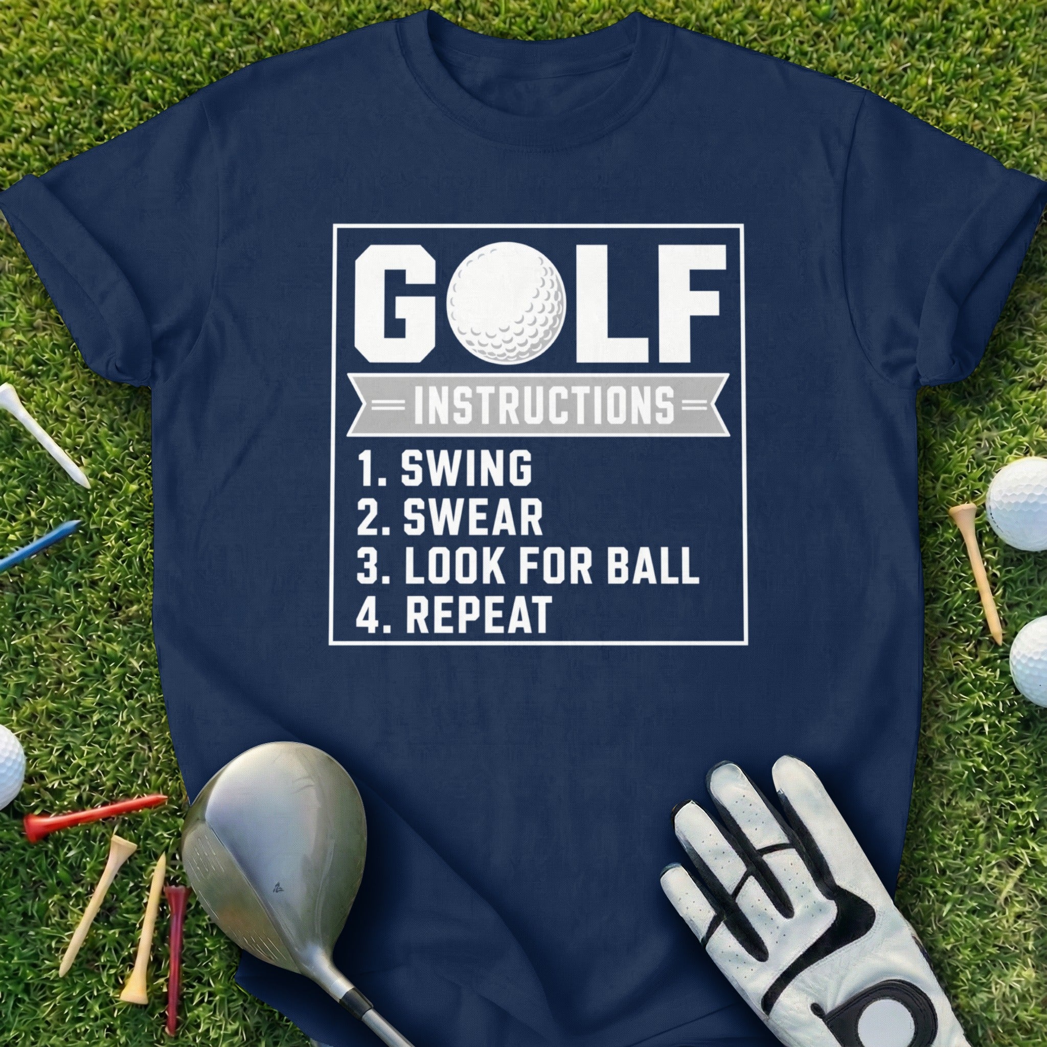 Navy t-shirt with "GOLF INSTRUCTIONS: 1. SWING 2. SWEAR 3. LOOK FOR BALL 4. REPEAT" text.