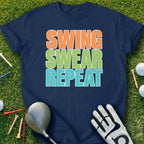 Navy t-shirt with "Swing Swear Repeat" text on a golf course background.