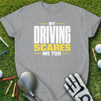 Grey t-shirt with "My Driving Scares Me Too" text, golf club, glove, and tees.