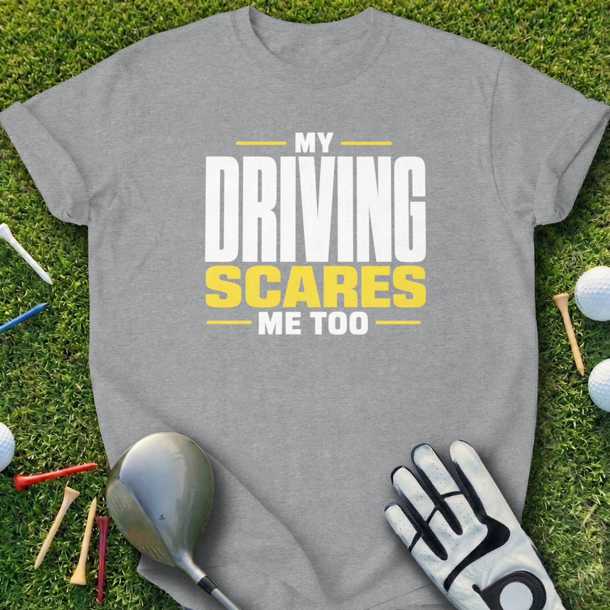 Grey t-shirt with "My Driving Scares Me Too" text, golf club, glove, and tees.
