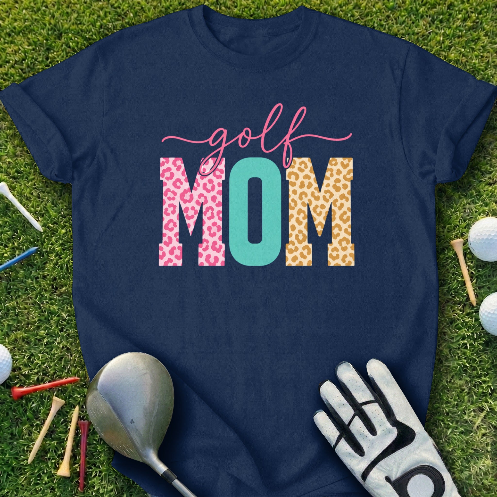 Navy t-shirt with "golf MOM" text in leopard print and argyle patterns.