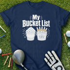 Navy t-shirt with "My Bucket List" text and graphics of golf balls and beer bottles.