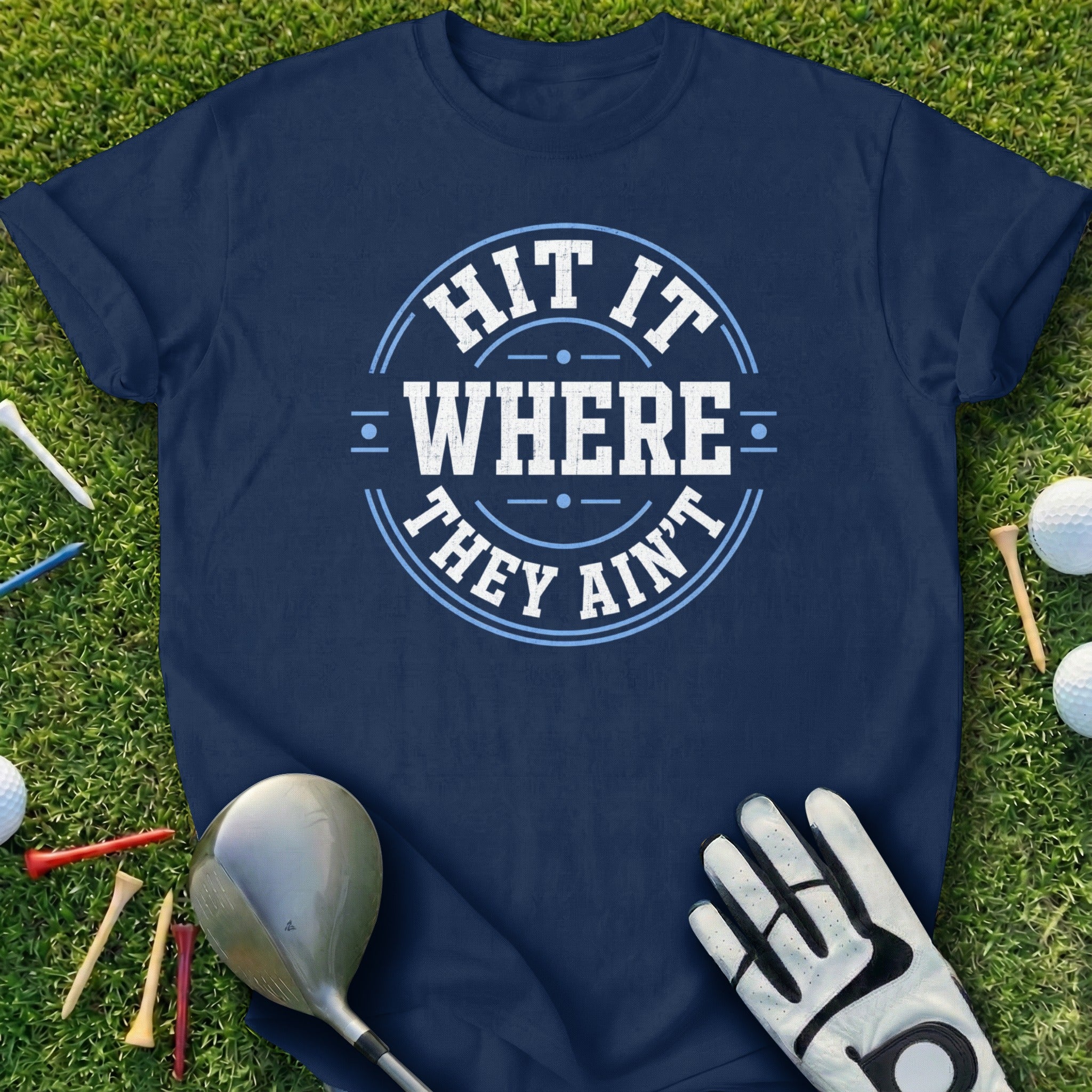 Navy t-shirt with "HIT IT WHERE THEY AIN'T" text and golf accessories.