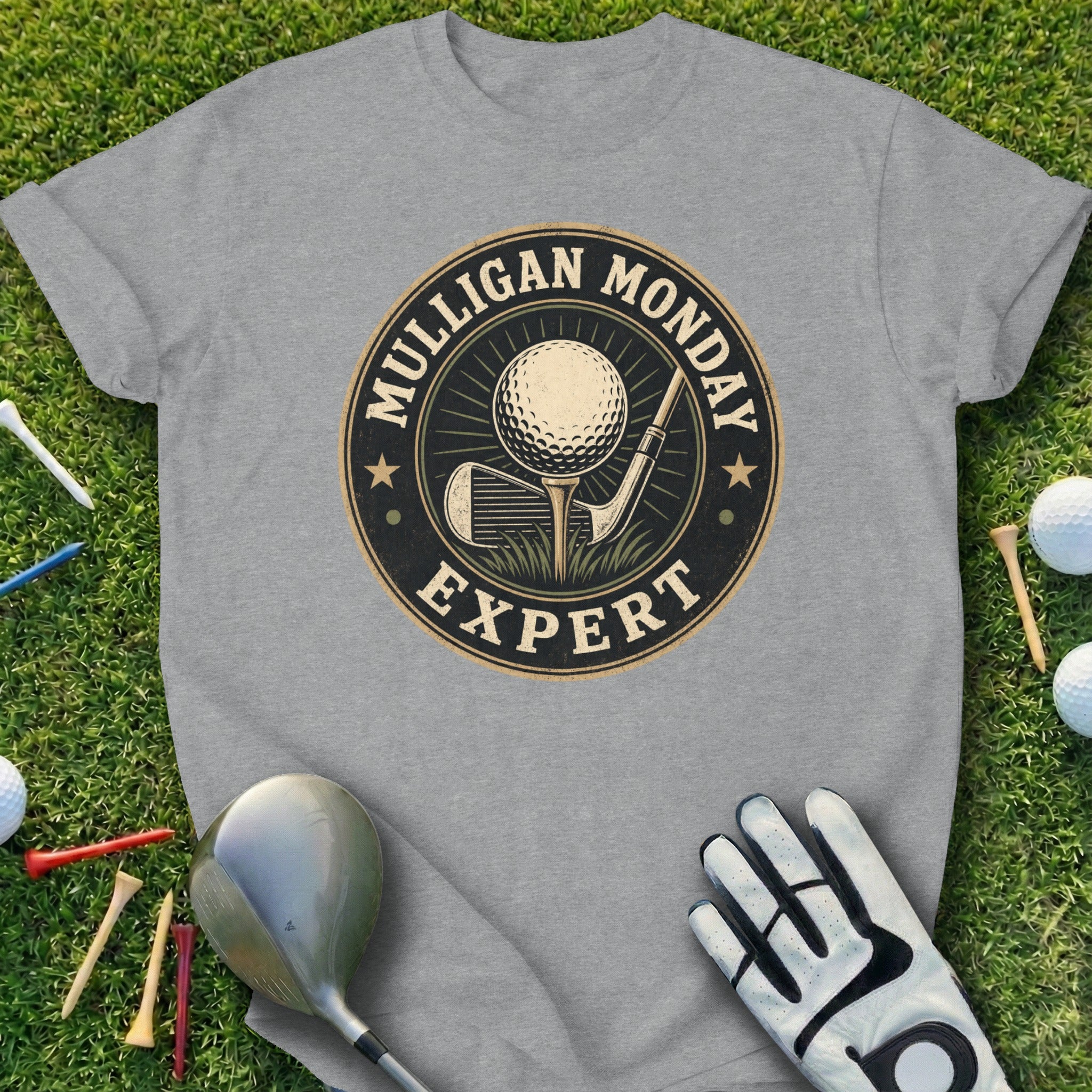 T-shirt with "Mulligan Monday Expert" text and golf club, ball, and tee graphic.