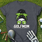 T-shirt with "GOLFMOM" text, sunglasses reflecting golf courses, and a messy bun.