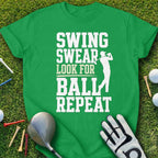 Green t-shirt with "Swing Swear Look For Ball Repeat" text and golfer silhouette.