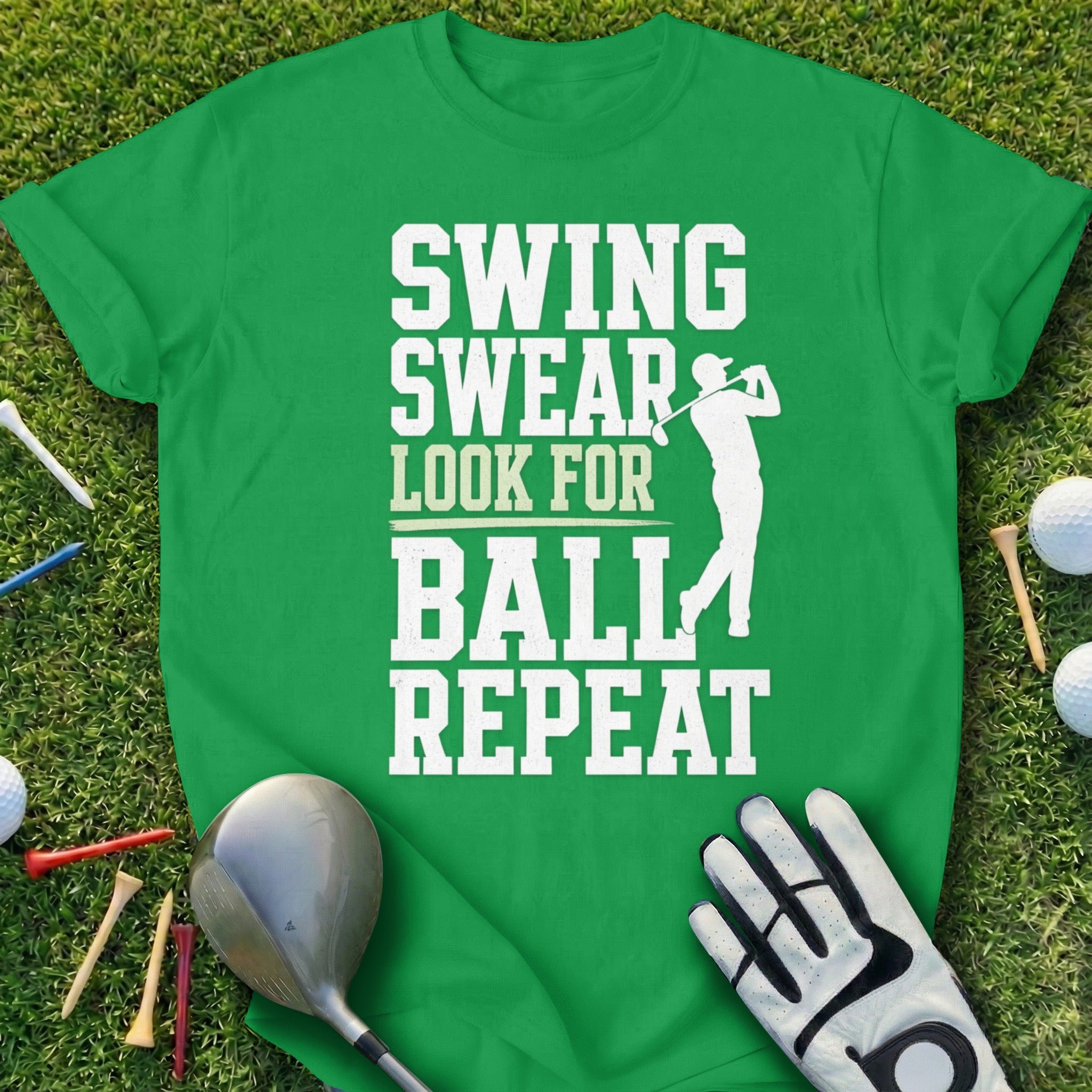Green t-shirt with "Swing Swear Look For Ball Repeat" text and golfer silhouette.