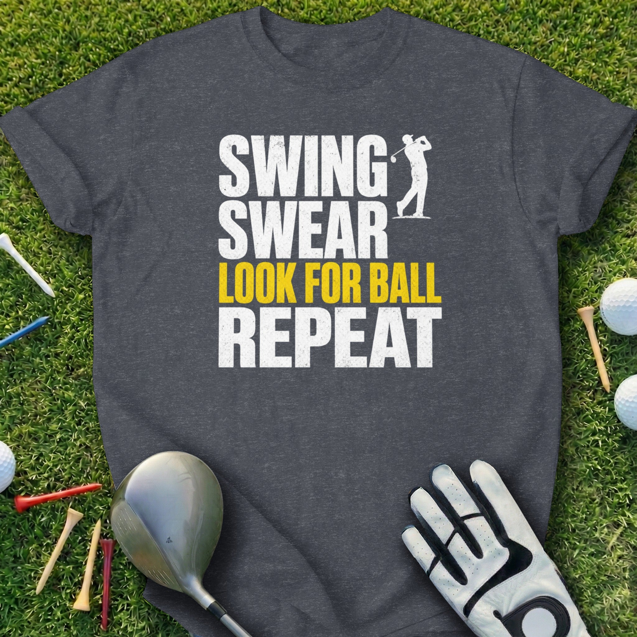 Dark t-shirt with "Swing Swear Look for Ball Repeat" text and golf items.