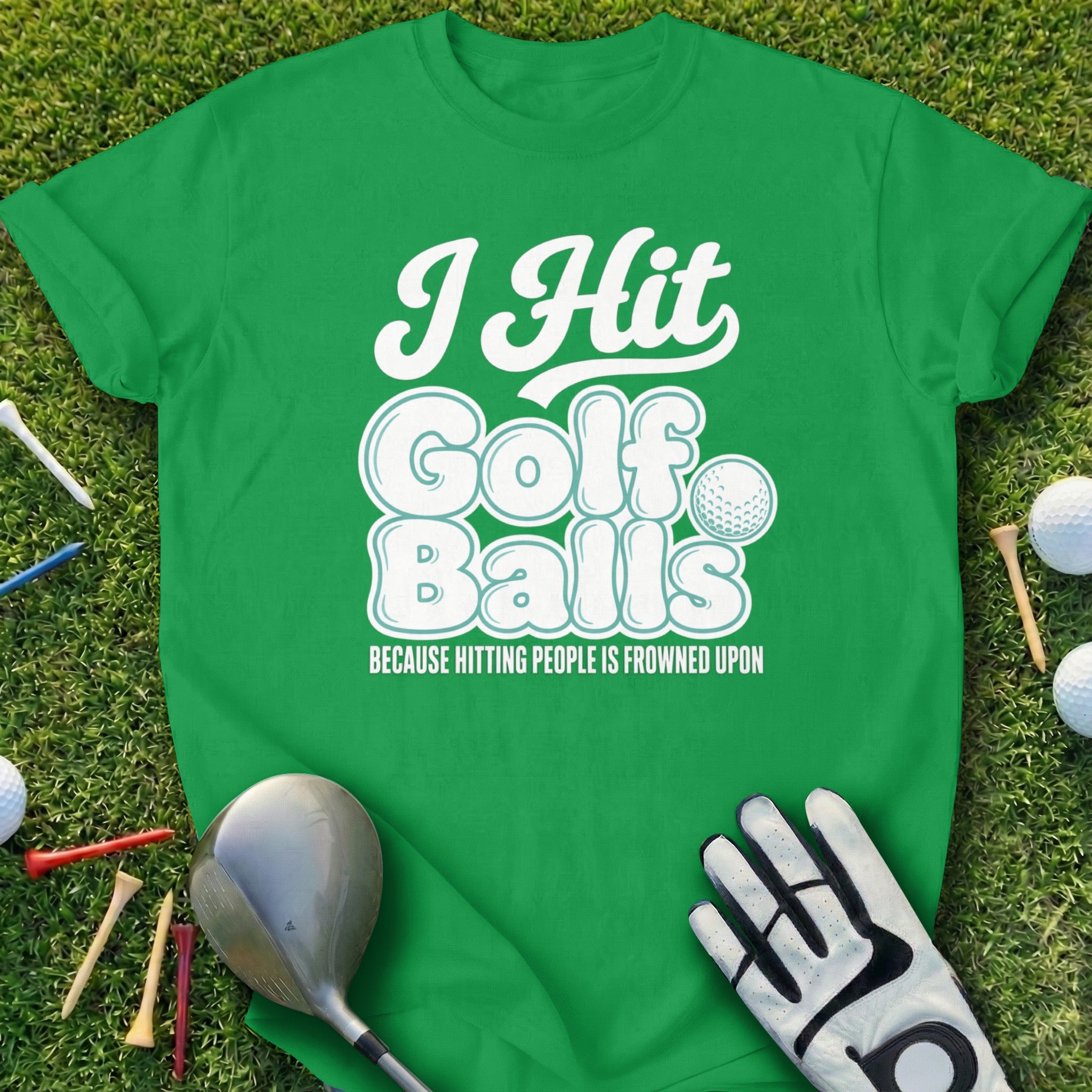 Green t-shirt with "I Hit Golf Balls" text and golf equipment.