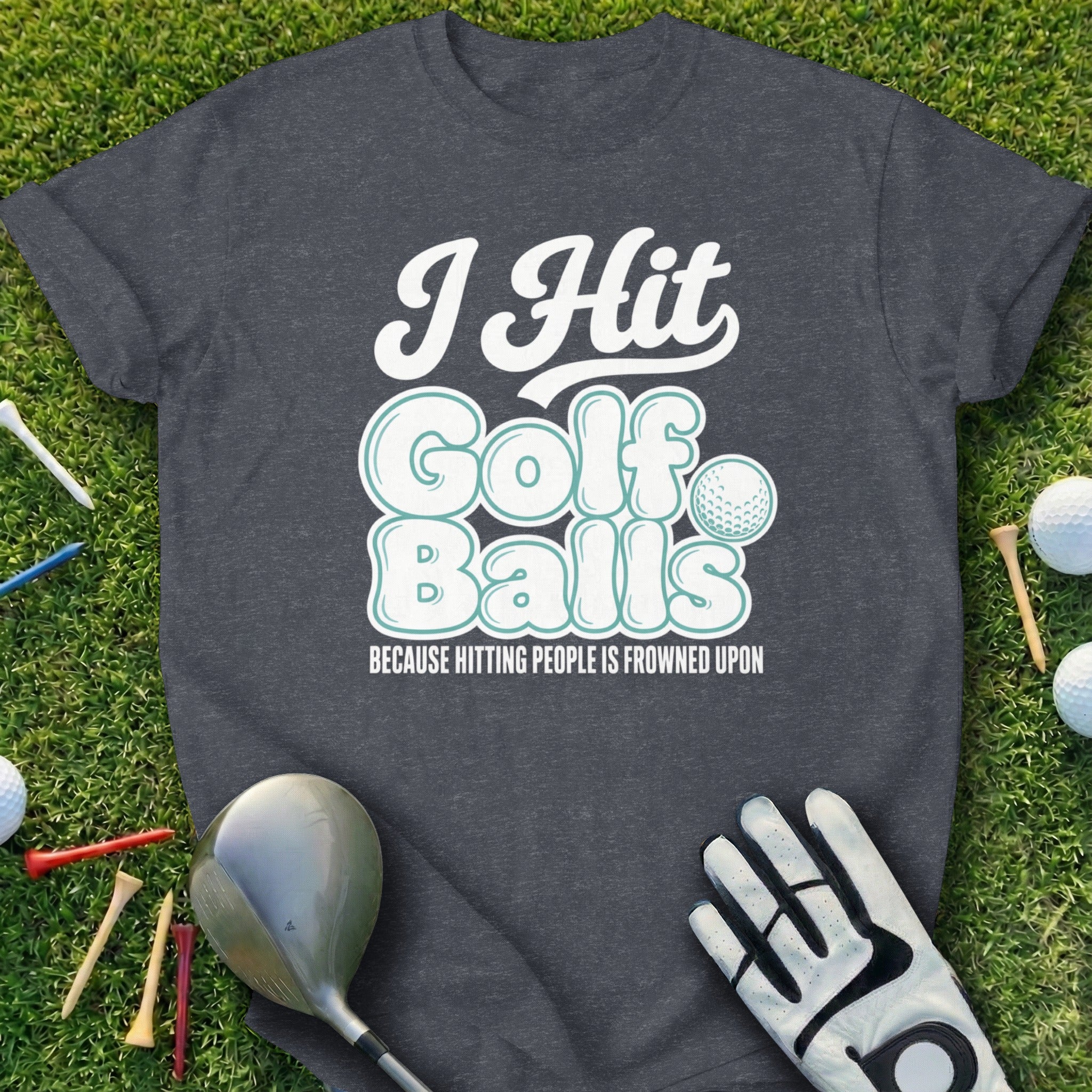 Dark gray t-shirt with "I Hit Golf Balls Because Hitting People Is Frowned Upon" text and golf accessories.
