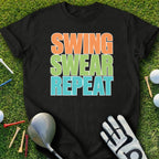 Black t-shirt with "SWING SWEAR REPEAT" in colorful text on a golf course.