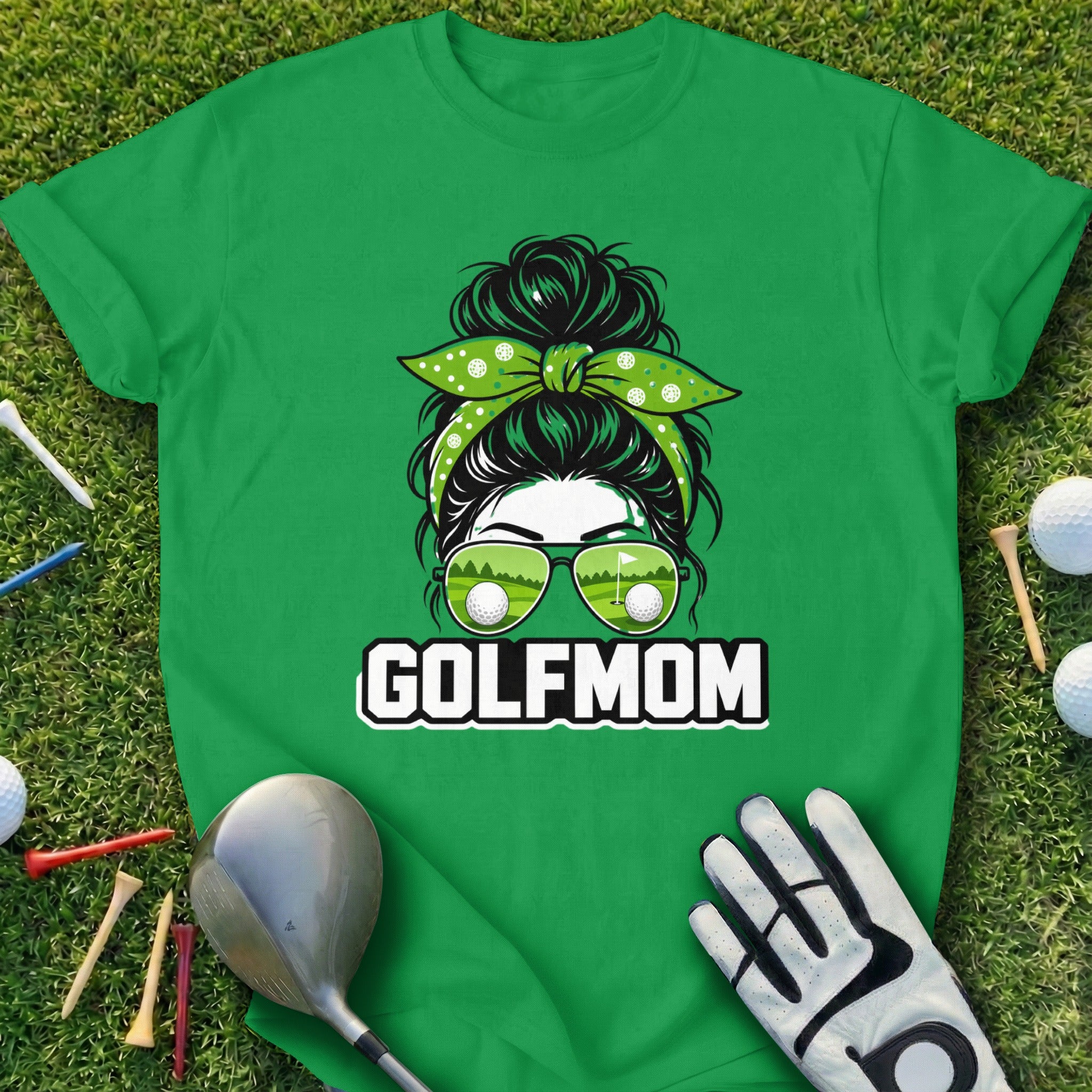 Green t-shirt with "GOLFMOM" text and sunglasses reflecting golf course.
