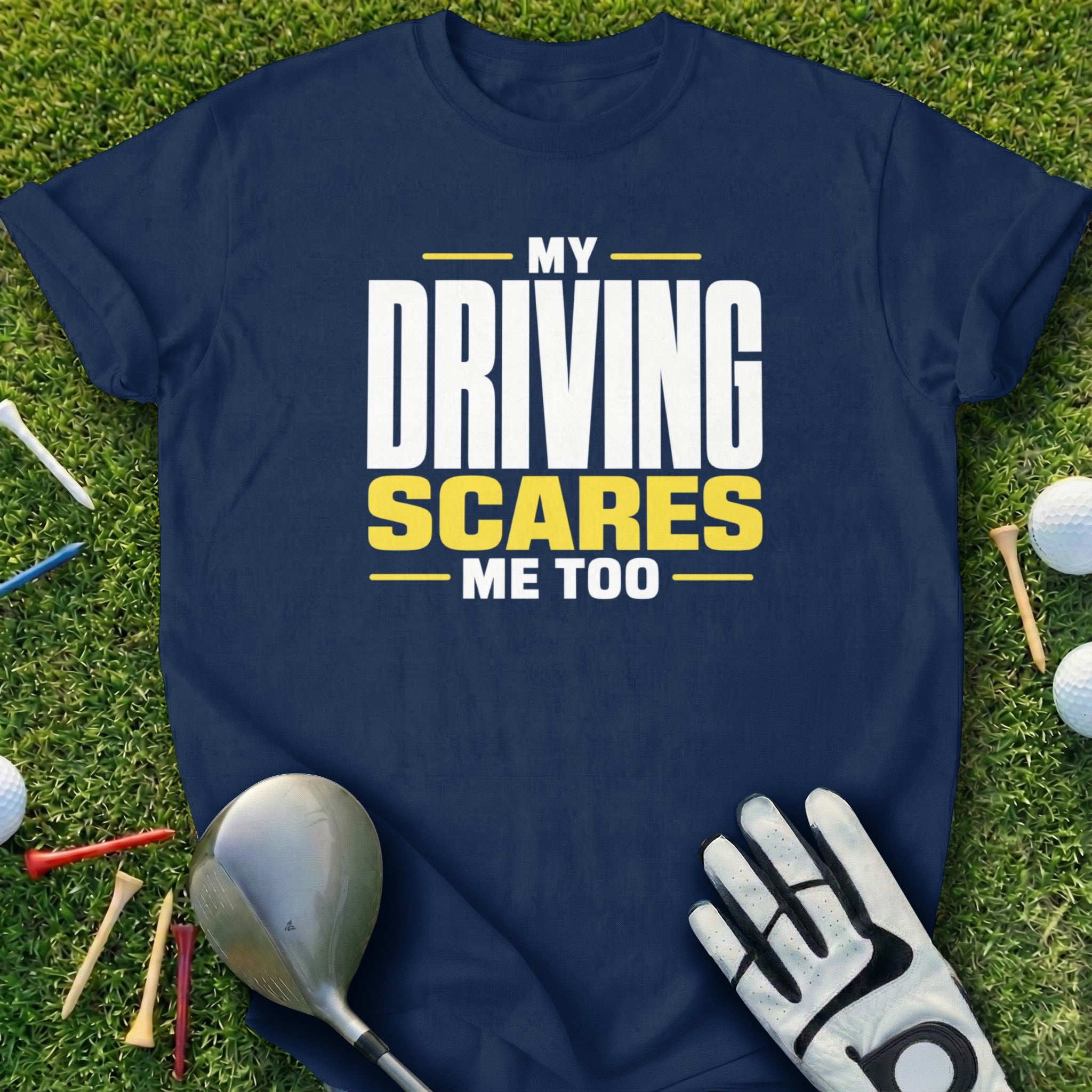 Navy t-shirt with "My Driving Scares Me Too" text, golf clubs, tees, and balls.