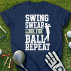 Navy t-shirt with white text "SWING SWEAR LOOK FOR BALL REPEAT" and a golfer graphic.