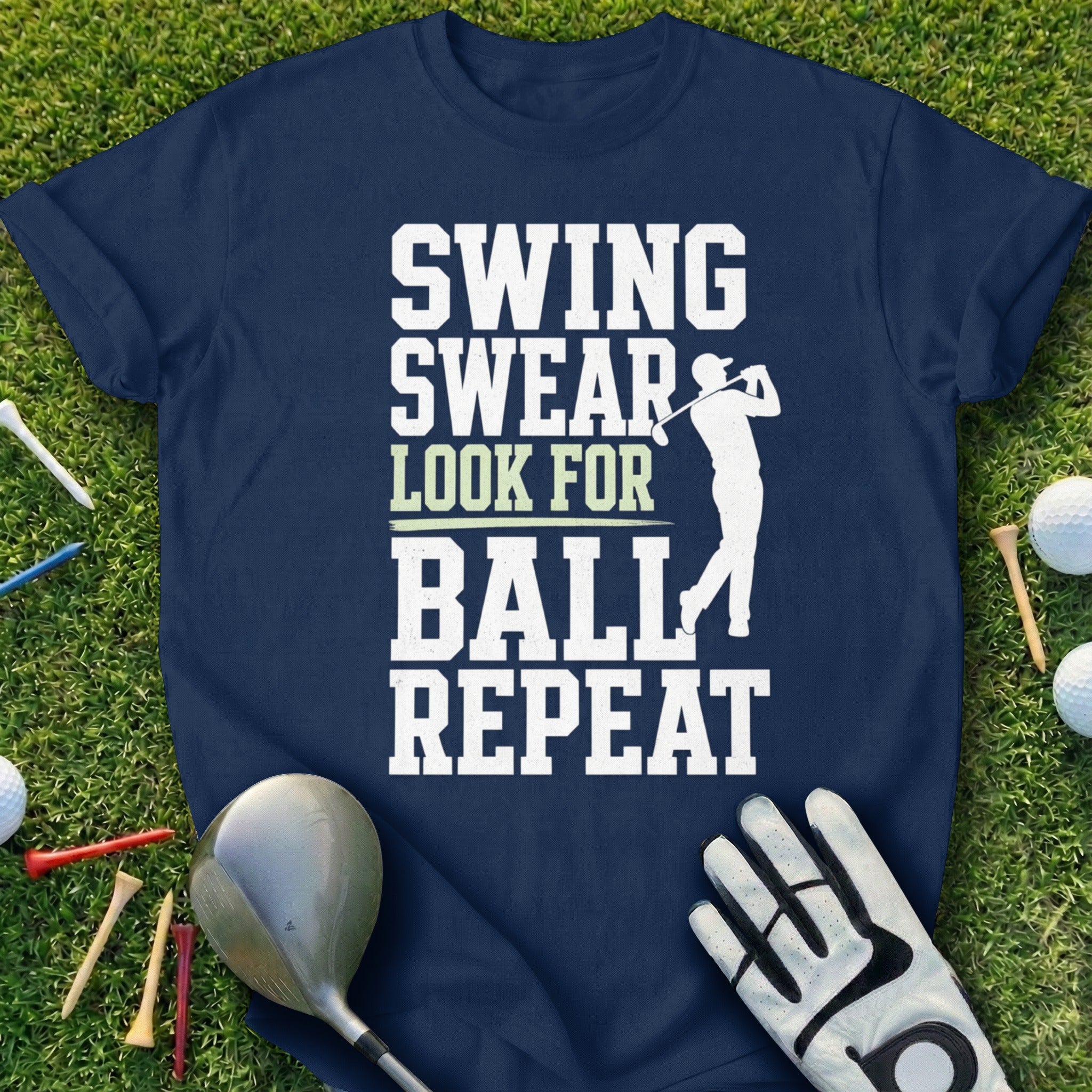 Navy t-shirt with white text "SWING SWEAR LOOK FOR BALL REPEAT" and a golfer graphic.