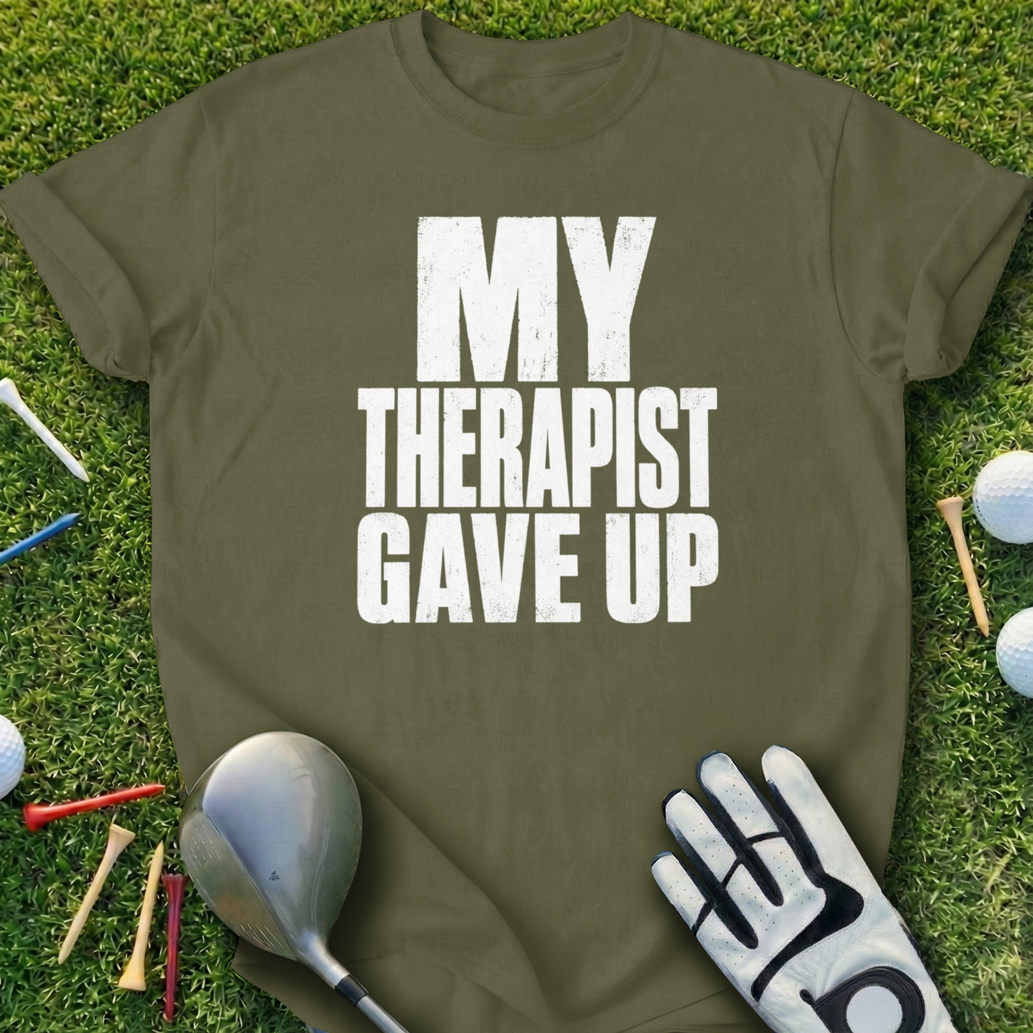 Olive green t-shirt with white text "MY THERAPIST GAVE UP".