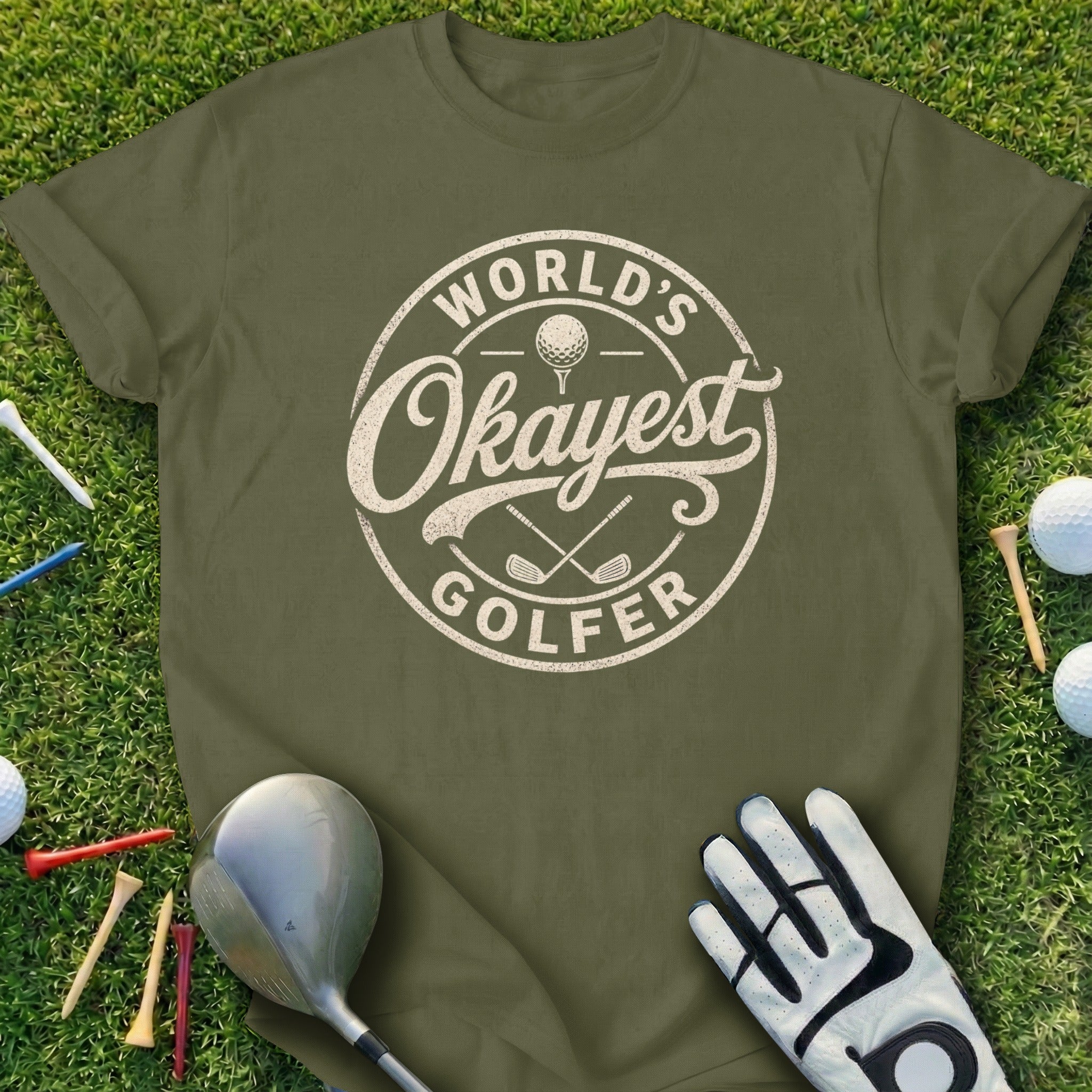 Green t-shirt with "World's Okayest Golfer" text and golf accessories.