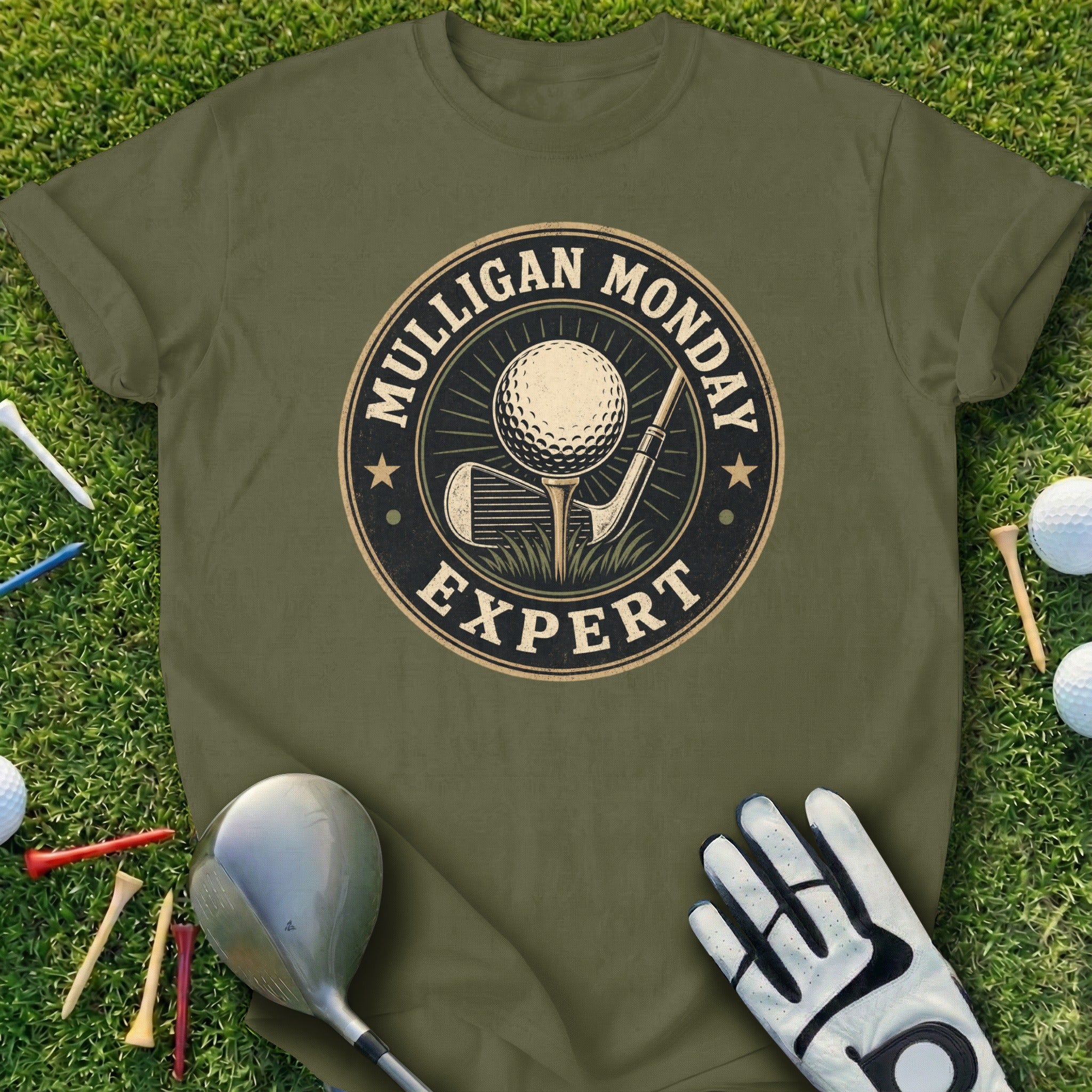 Green t-shirt with "Mulligan Monday Expert" logo featuring golf ball, tee, and clubs.