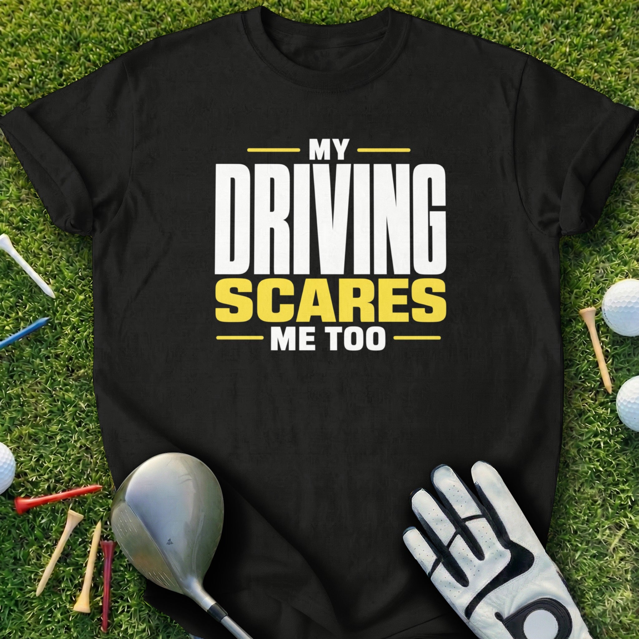 Black t-shirt with "MY DRIVING SCARES ME TOO" text, golf club, glove, and tees.