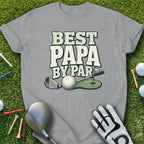 T-shirt with "Best Papa By Par" text, golf club, ball, and glove on grass.