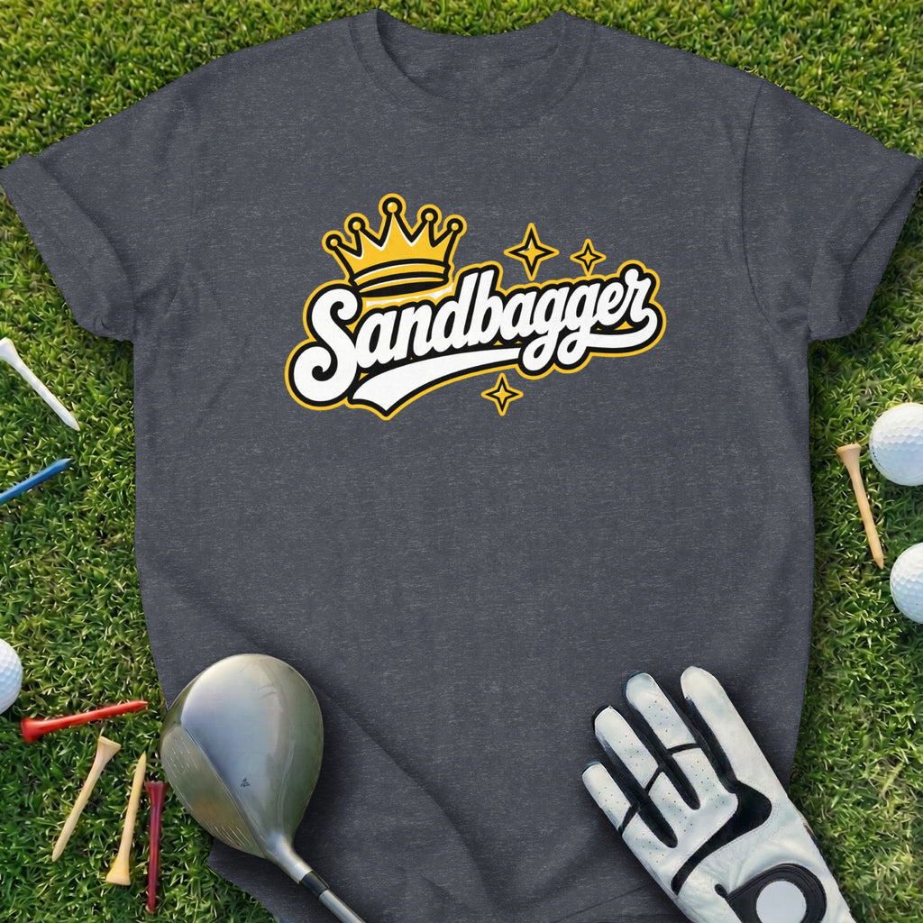 Dark gray t-shirt with "Sandbagger" logo and golf accessories on grass.