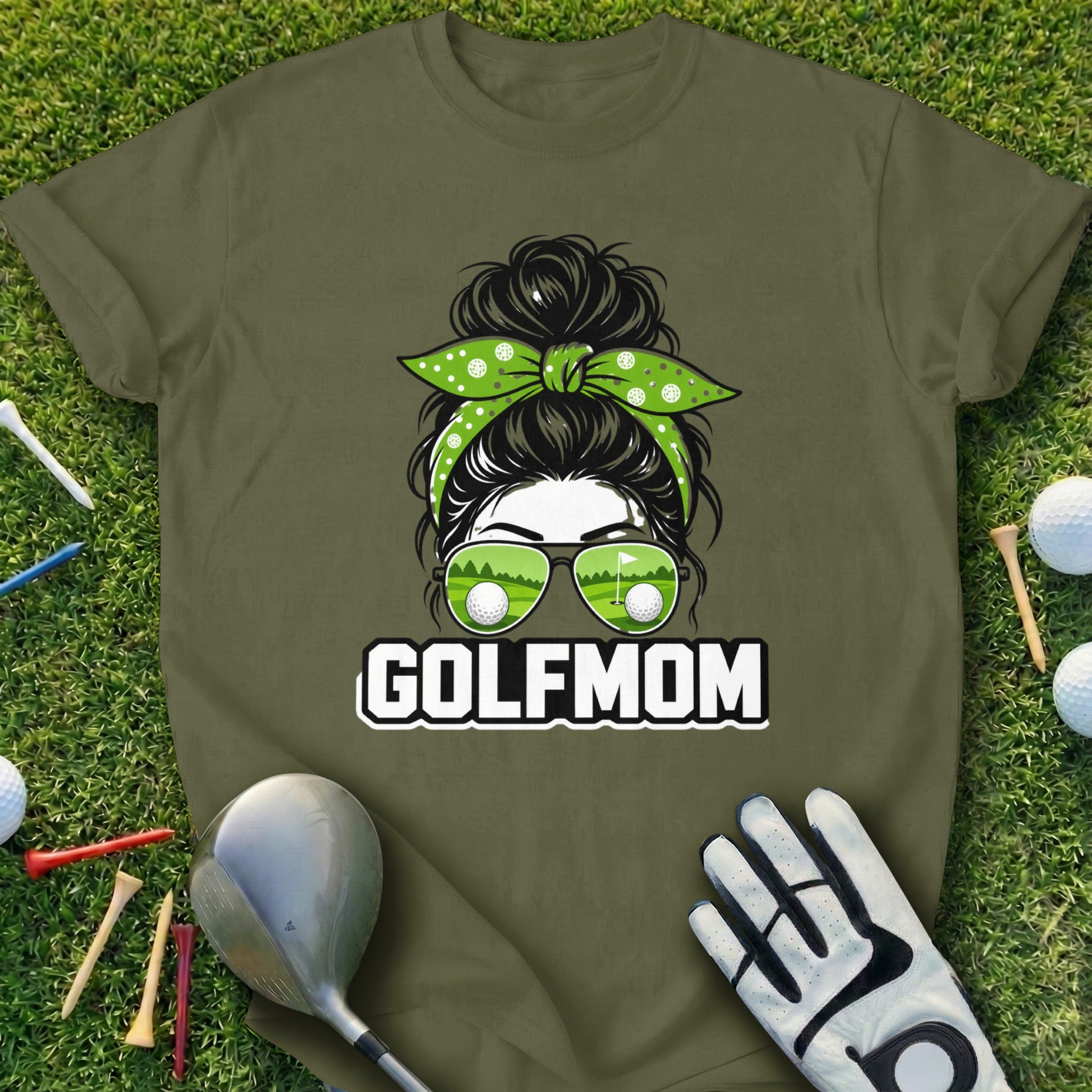 Green t-shirt with "GOLF MOM" text and woman with golf ball sunglasses.