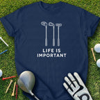 Navy t-shirt with golf club silhouettes and "Life is Important" text.