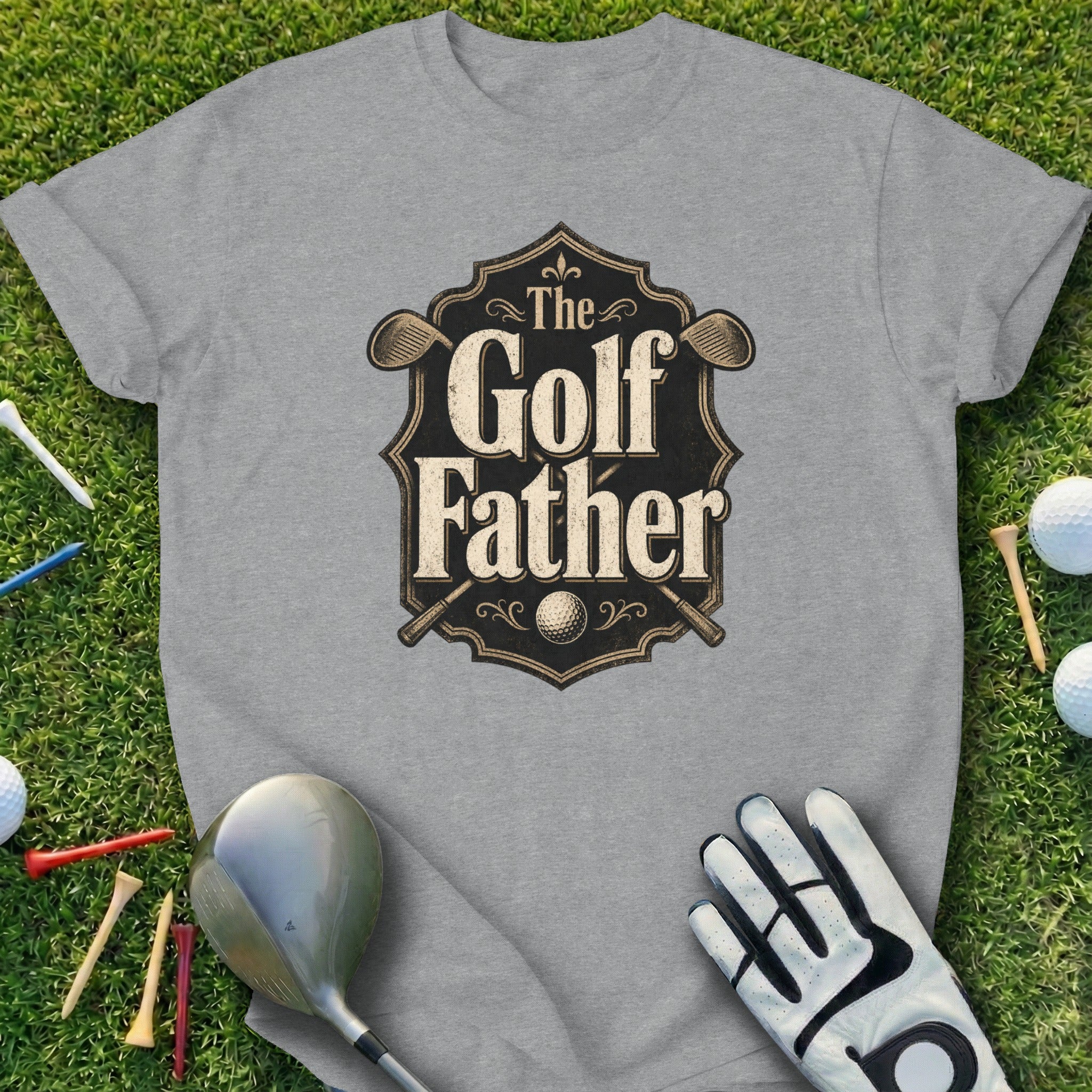 Grey t-shirt with "The Golf Father" text and crossed golf clubs design.