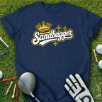 Navy t-shirt with "Sandbagger" crown logo, golf glove, and clubs.