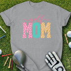 Grey t-shirt with "Golf MOM" text in leopard print and honeycomb patterns.