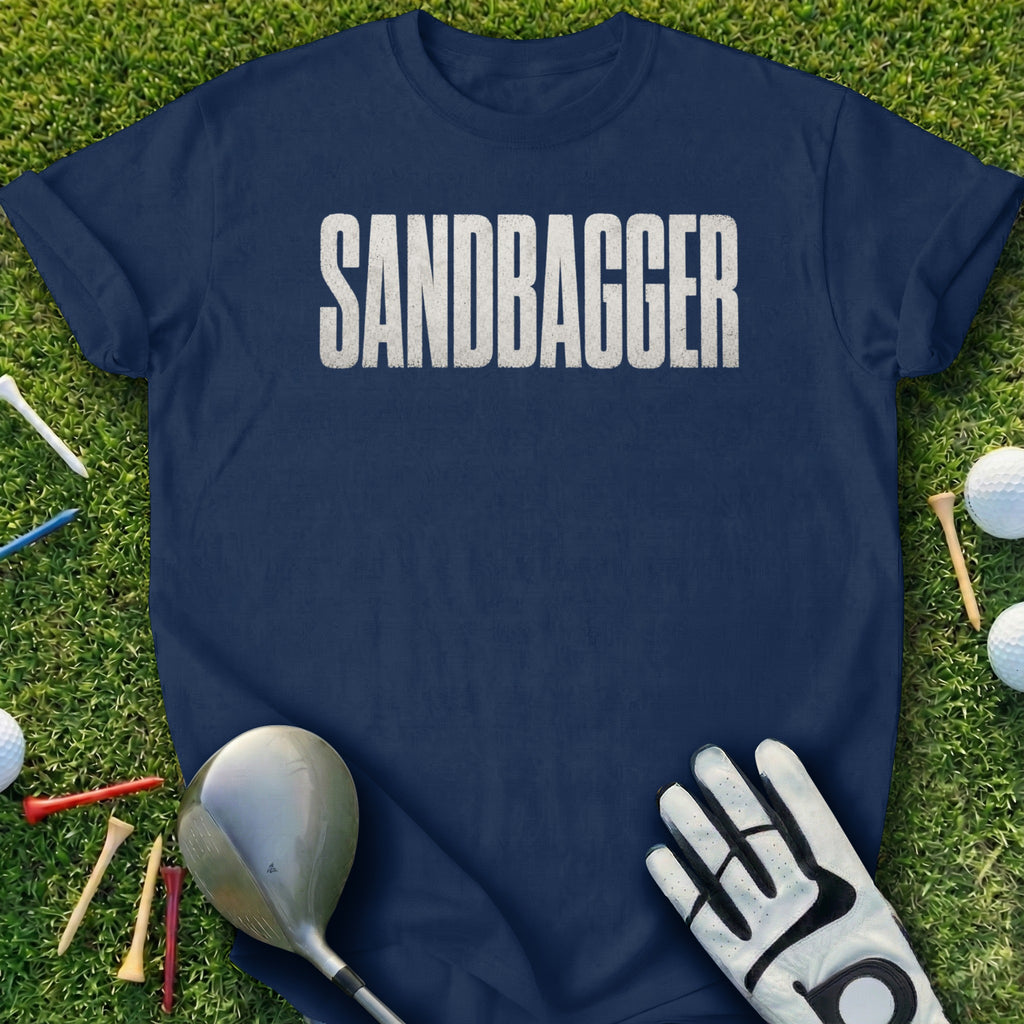 Navy t-shirt with "SANDBAGGGER" in white text, with golf accessories.