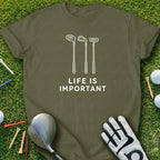 Green t-shirt with "LIFE IS IMPORTANT" and golf club graphics.
