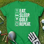 Green t-shirt with "Eat. Sleep. Golf. Repeat." text and golf equipment.