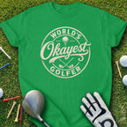 Green t-shirt with "World's Okayest Golfer" text and golf accessories.