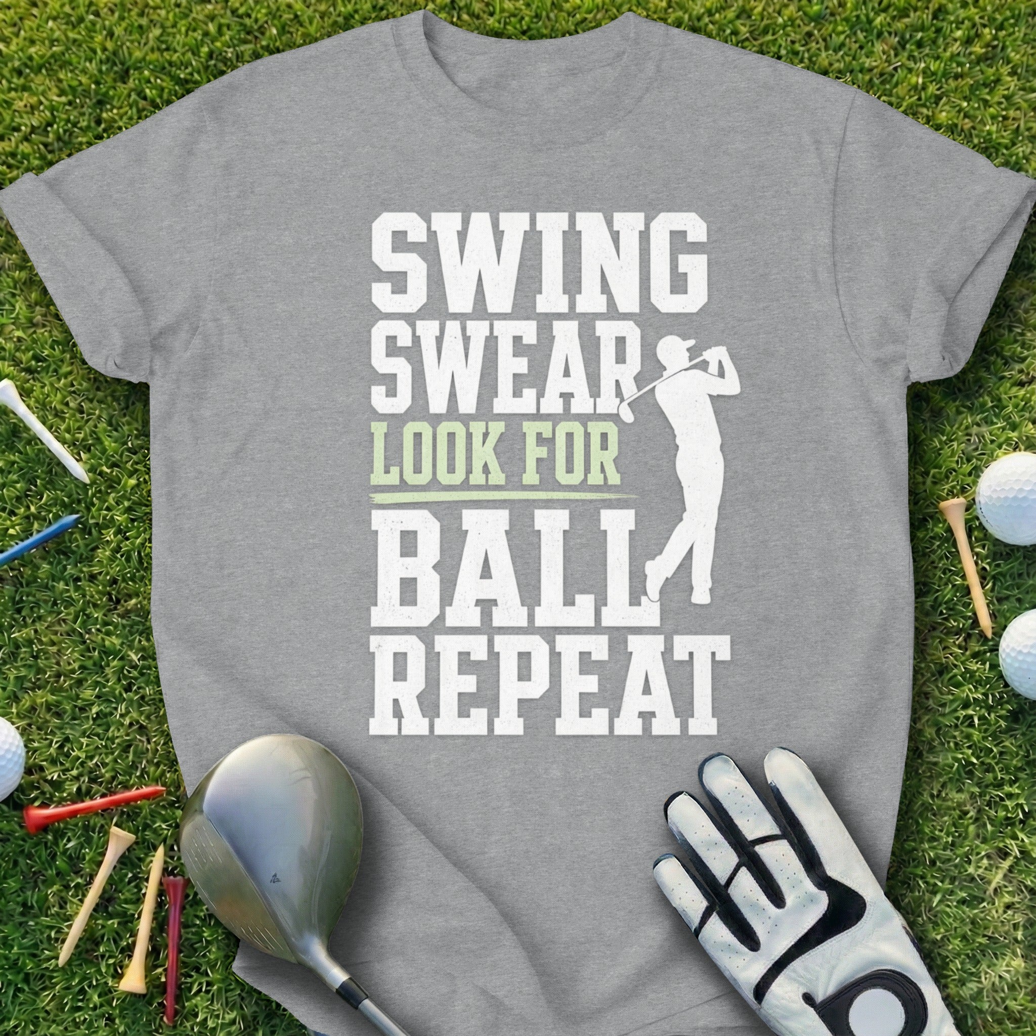 Gray t-shirt with "Swing Swear Look for Ball Repeat" text and golfer graphic.