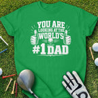 Green t-shirt with "YOU ARE LOOKING AT THE WORLD'S #1 DAD" text and golf imagery.